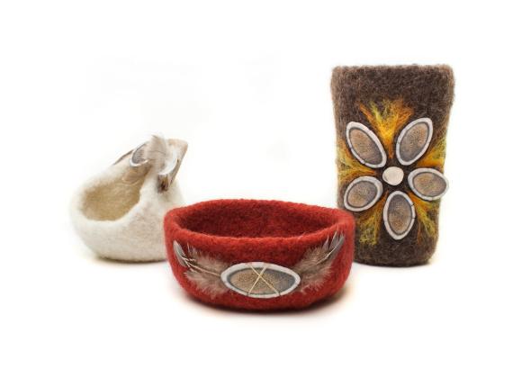 Vessels with caribou antler and feather accents